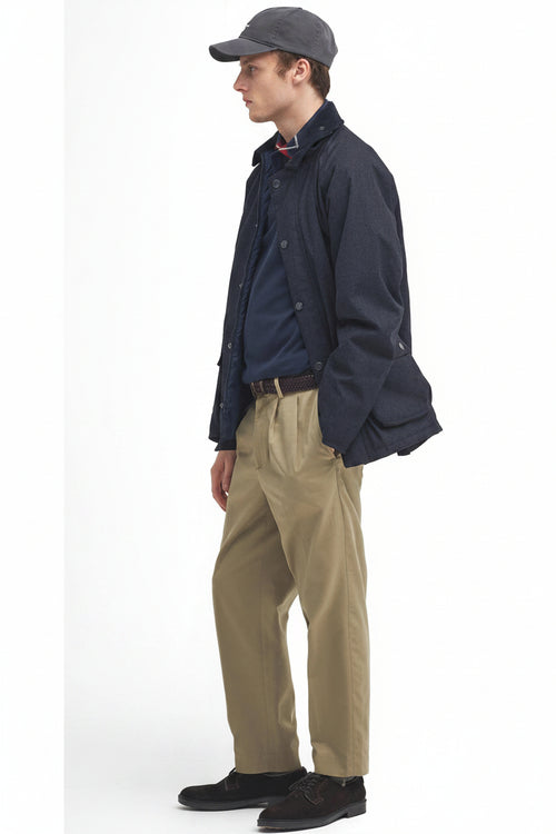 Navy waterproof Bedale jacket, stand collar, button front, worn with tan trousers