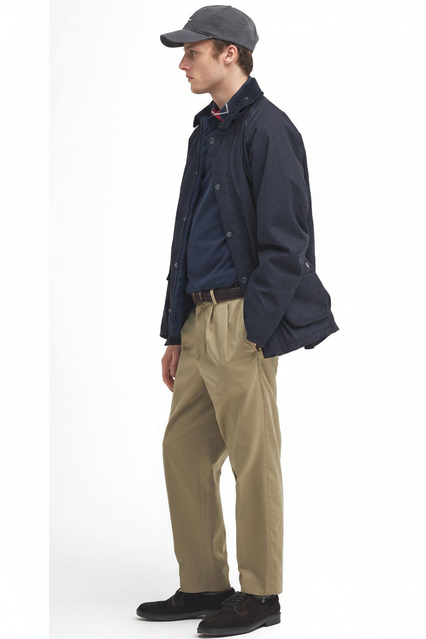 Navy waterproof Bedale jacket, stand collar, button front, worn with tan trousers