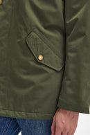 Olive waterproof jacket side pocket with Barbour badge snap detail