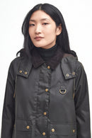 Waxed jacket with hood in dark olive, brass snap buttons, two front pockets, brand patch.