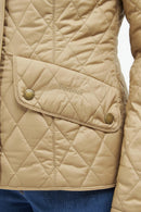 Quilted Barbour jacket with diagonal button placket, tan fabric and gold-tone snaps