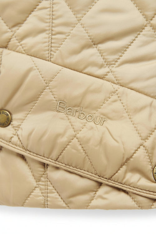 Quilted tan jacket front with Barbour logo and diagonal storm flap