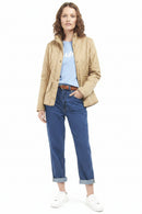 Tan quilted jacket with high collar, snap front, and diamond stitch pattern