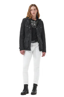Women’s black wax jacket worn over white jeans, with snap-button front and pockets