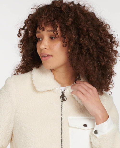 White fleece jacket with high collar, zip front, and chest pocket