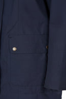 Navy jacket chest pocket with Barbour logo patch and snap button