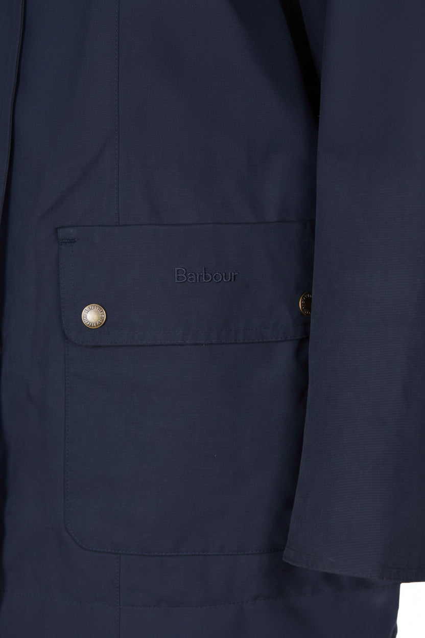 Navy jacket chest pocket with Barbour logo patch and snap button