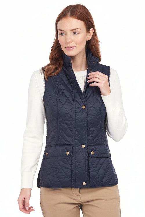 Women's navy quilted gilet with zip front, gold buttons and patch pockets; worn open