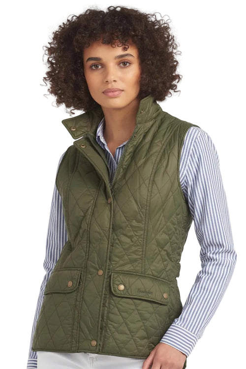 Olive quilted Barbour gilet with button pockets and zip front, worn with striped shirt.