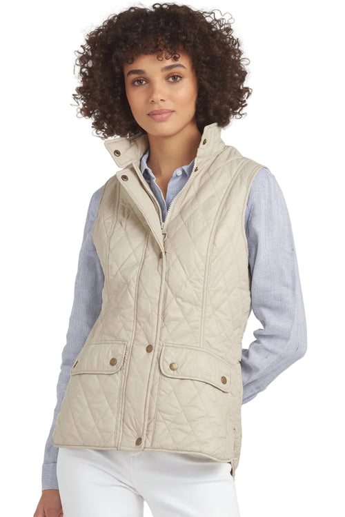 Women's quilted gilet with stand collar, front zip, and two flap pockets.