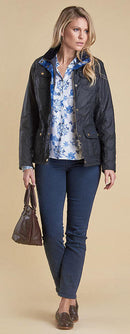 Women’s navy wax jacket with button front, flap pockets, blue floral lining