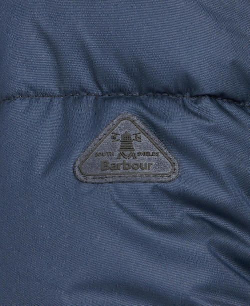 Navy quilted jacket interior panel with Barbour logo patch and stitched quilting lines