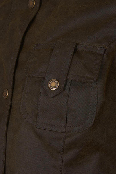 Olive wax jacket close-up of chest patch pockets with Barbour crest button