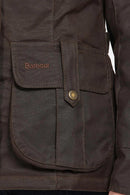 Barbour wax jacket front pocket with “Barbour” label patch and brass snap