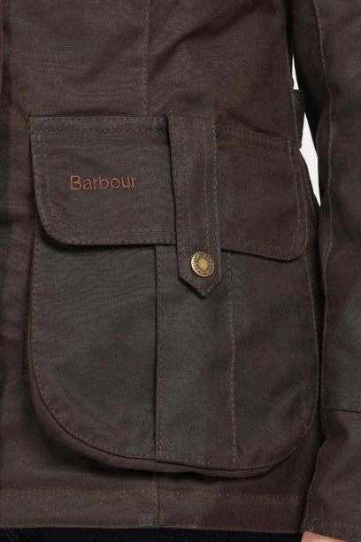 Barbour wax jacket front pocket with “Barbour” label patch and brass snap