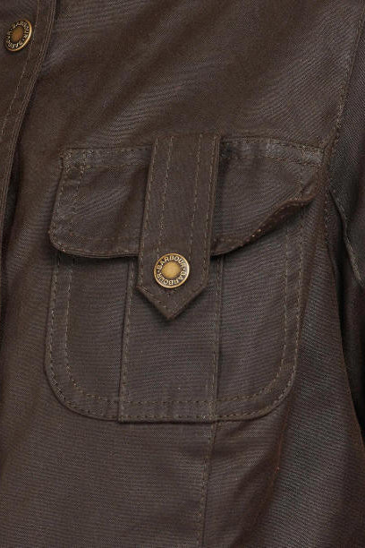 Barbour wax jacket pocket flap with round logo button and stitched detail