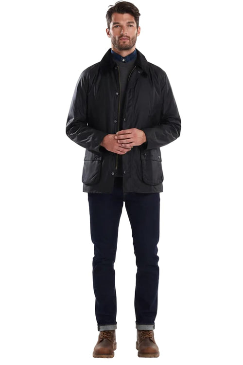 Men's black wax jacket with stand collar, snap front, and side pockets