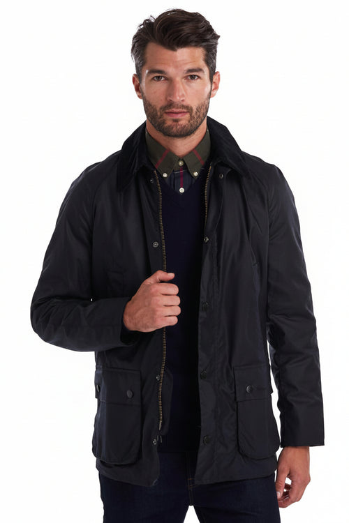 Navy wax jacket with button front, stand collar, and flap pockets