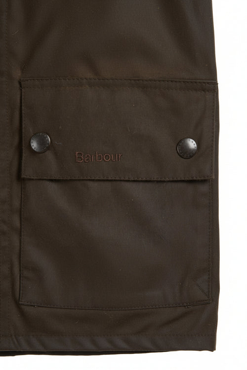 Close-up of olive waxed jacket pocket with snap buttons and Barbour logo