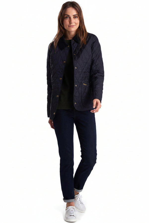Women's navy quilted jacket on model, button front and diamond quilting