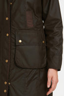 Women's dark olive wax cotton jacket, side pocket detail with gold button and quilted paneling
