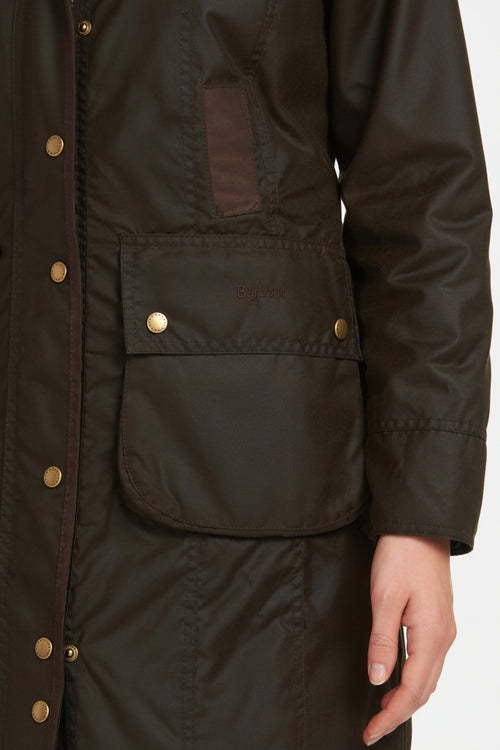 Women's dark olive wax cotton jacket, side pocket detail with gold button and quilted paneling