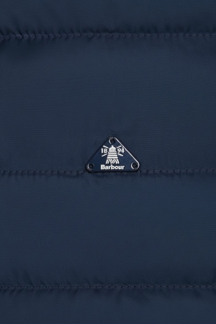 Barbour logo patch on navy quilted jacket with metal eyelet pull tab