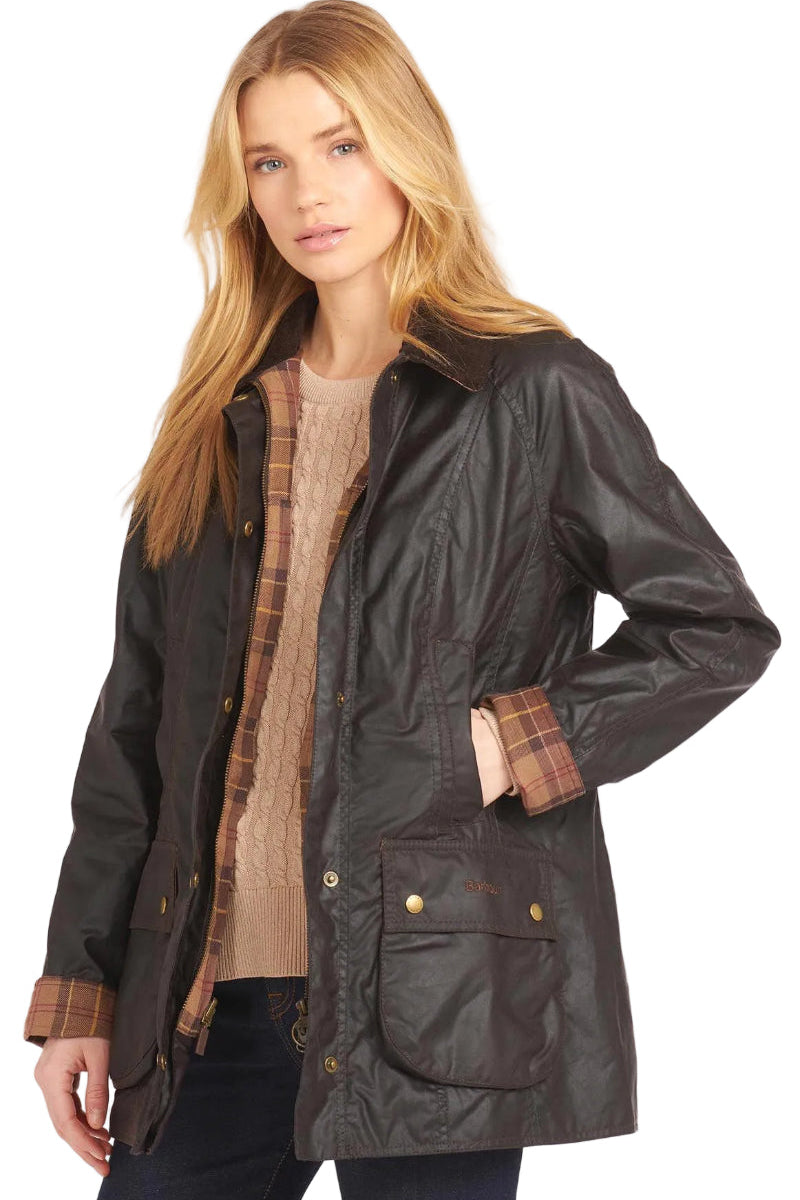 Ladies dark wax jacket with plaid lining, gold snaps, front patch pockets, stand collar