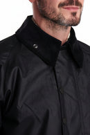 Black wax jacket collar detail with snap buttons and textured inner trim