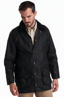 Men's black wax jacket with snap front, stand collar, and two flap pockets