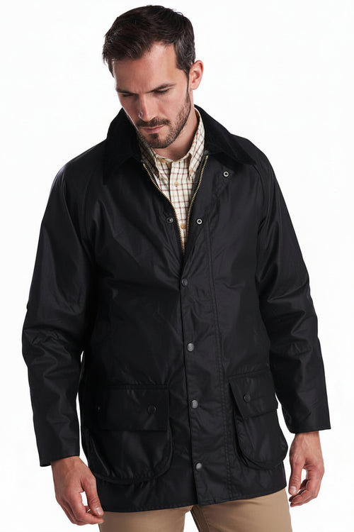 Men's black wax jacket with snap front, stand collar, and two flap pockets