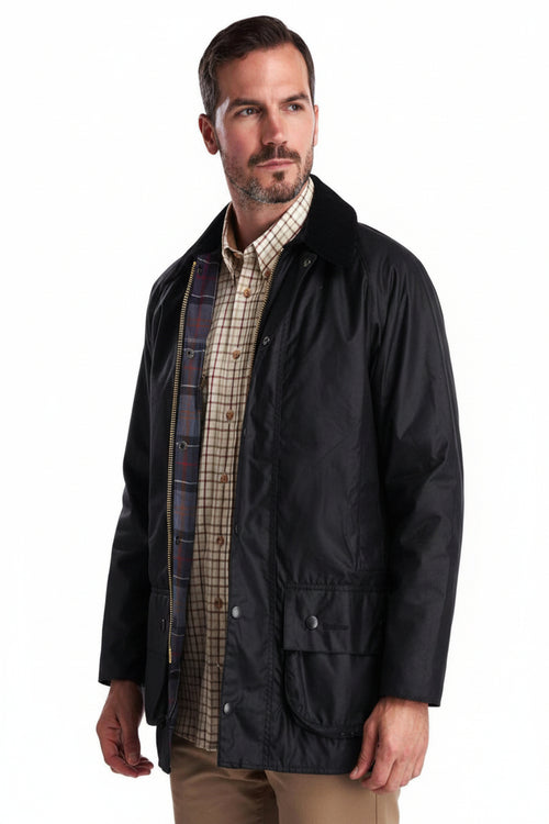 Men's black Barbour wax jacket with tartan-lined collar and side pocket