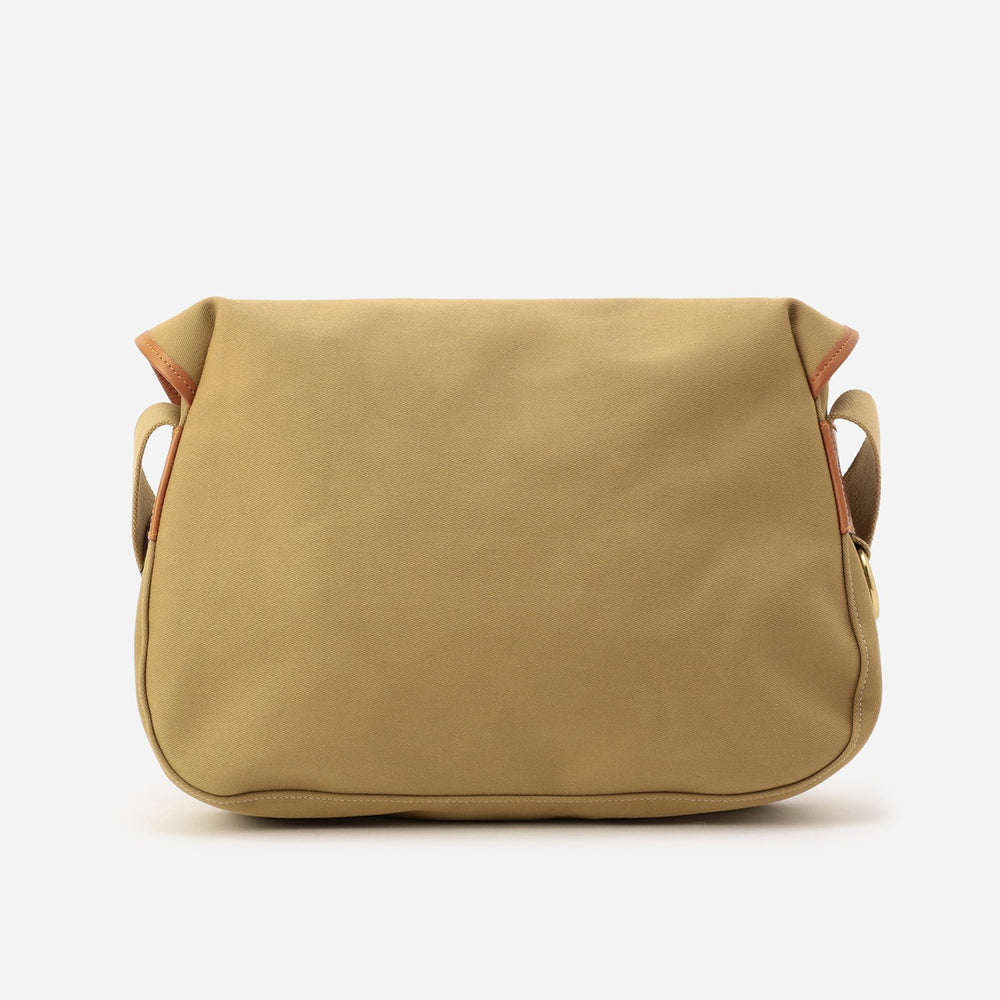 Khaki canvas bag back with side openings and brown leather trim