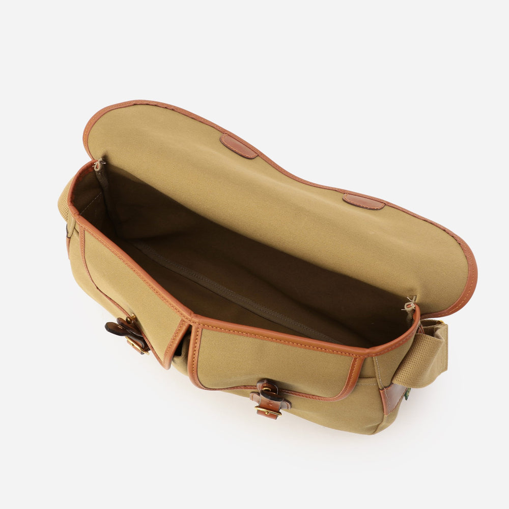 Khaki canvas bag interior with tan lining and stitched leather edge trim