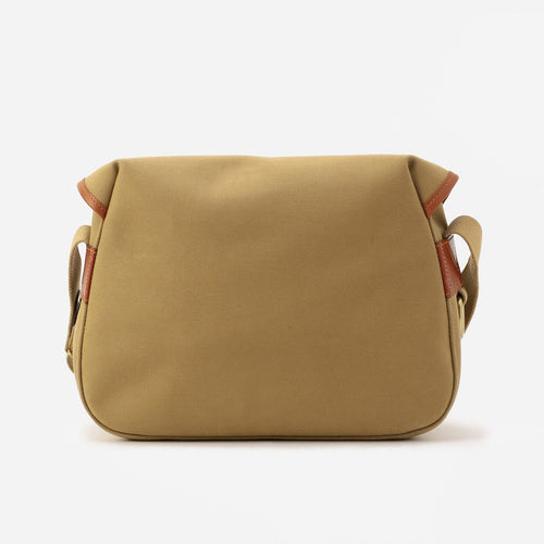Khaki small crossbody bag with curved back panel and brown leather edge trim