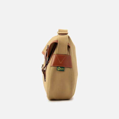 Khaki small crossbody bag side view with top carry handle and brown leather trim