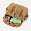 Small khaki crossbody bag shown open with interior pockets and brown leather trim