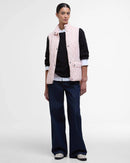 Barbour women's quilted pink gilet worn over dark sleeves with button front