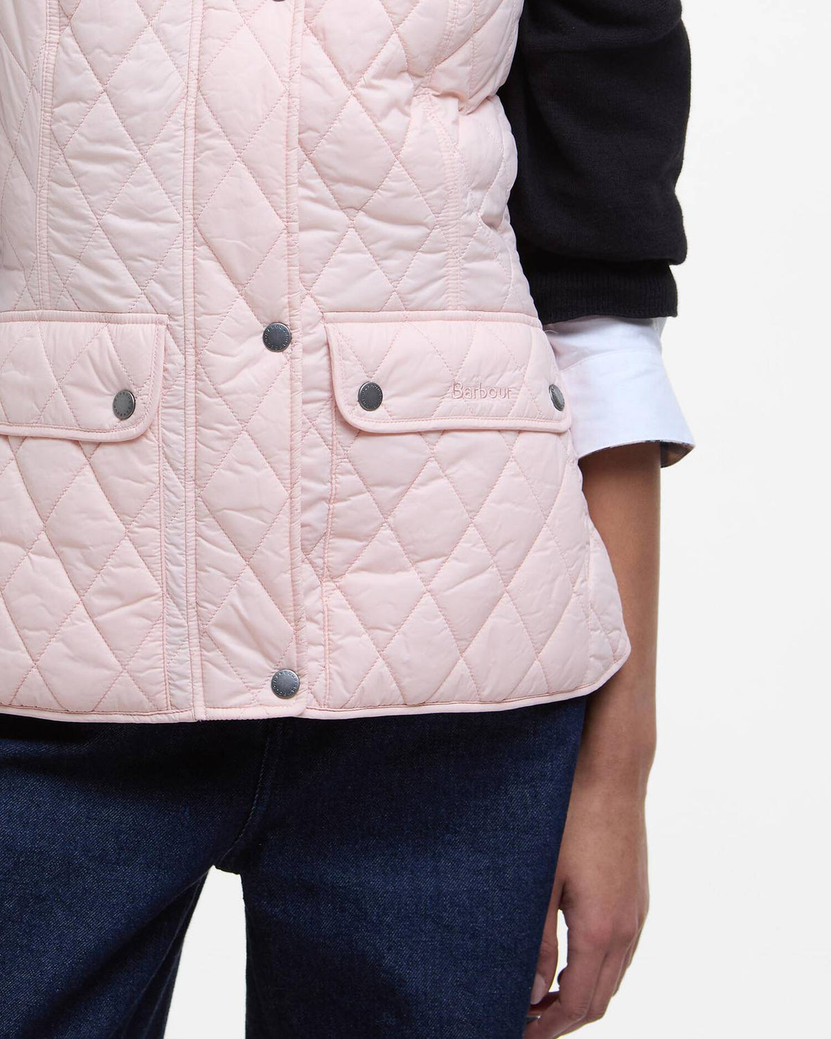Barbour women's pink quilted gilet side view with flap pockets and button closure