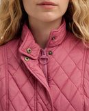 Wildberry pink quilted gilet detail: stand collar, zip pull, snap button closures