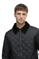 Barbour men's black quilted jacket close-up with stand collar and button placket