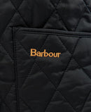 Barbour logo on black quilted jacket pocket, close-up