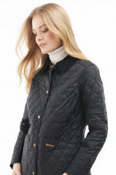 Black quilted women’s jacket with button front and stand collar, 3/4 side view
