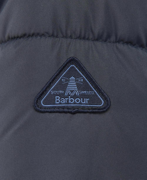 Barbour logo patch on dark navy quilted jacket, triangle badge detail