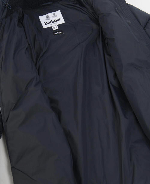 Dark navy quilted jacket chest area with Barbour label and zip-front