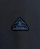 Embroidered Barbour triangle logo badge on dark navy fabric