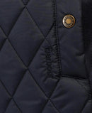 Navy quilted gilet close-up with Barbour round badge and branded zipper pull