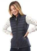 Navy quilted Barbour gilet on model with gold zip, stand collar, and side pockets