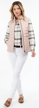 Pastel pink quilted gilet with zip-front, high collar, and diamond quilt pattern