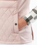 Pastel pink quilted gilet with side pocket, snap buttons, and diamond quilting